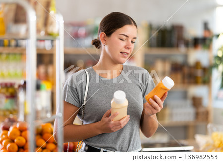Woman choosing sauce in the store 136982553