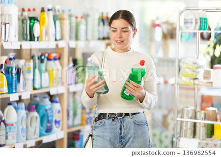 woman chooses dishwashing detergents 136982554