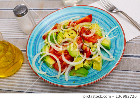 Salad with fresh tomatoes, ripe avocado and onion Salad with fresh tomatoes, ripe avocado and onion 136982726