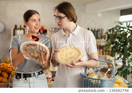 In shop European youth girl and guy scan QR code and take reading pizza using phone camera 136982746