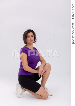 Mobility and flexibility training, Rehabilitation stretch with focused guidance, Fitness coach guides kneeling stretch focusing on recovery and flexibility enhancement 136983724