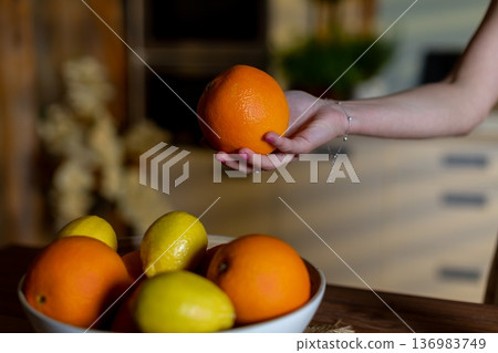 Fruit bowl scene, Kitchen setup with citrus fruits, Casual breakfast display with fresh produce, Cozy kitchen ambiance featuring oranges and lemons on wooden surface Fruit bowl scene, Kitchen setup with citrus fruits, Casual breakfast display with fresh produce, Cozy kitchen ambiance featuring oranges and lemons on wooden surface 136983749