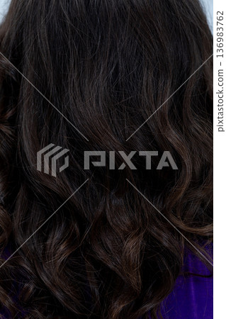 Sparkling tips and polished surface enhance detailed hairstyle, Subtle shimmer on dark hair creates tactile glossy look highlighting curl ends and surface refinement Sparkling tips and polished surface enhance detailed hairstyle, Subtle shimmer on dark hair creates tactile glossy look highlighting curl ends and surface refinement 136983762