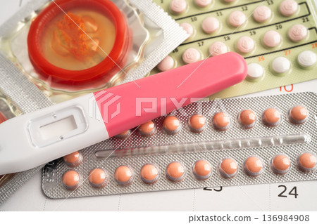 Pregnancy test and birth control pills on calendar, contraception health and medicine. Pregnancy test and birth control pills on calendar, contraception health and medicine. 136984908