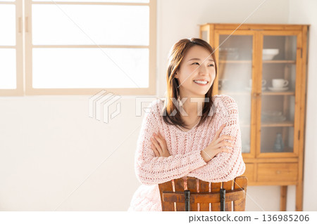 A young woman relaxing in the room A young woman relaxing in the room 136985206