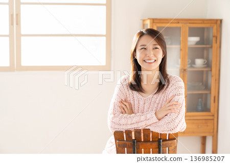 A young woman relaxing in the room A young woman relaxing in the room 136985207