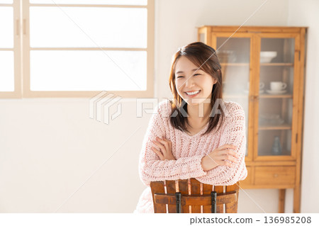 A young woman relaxing in the room A young woman relaxing in the room 136985208