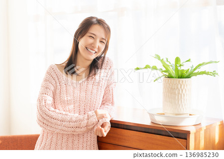 A young woman relaxing in the room A young woman relaxing in the room 136985230