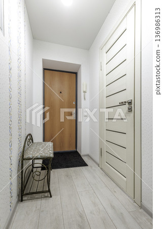 Cozy Entryway with Patterned Wallpaper and Wooden Entrance Door Cozy Entryway with Patterned Wallpaper and Wooden Entrance Door 136986313