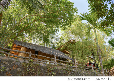 Adobe hut covered with straw of the ancient Miao tribe on the island of Hainan in China Adobe hut covered with straw of the ancient Miao tribe on the island of Hainan in China 136986419