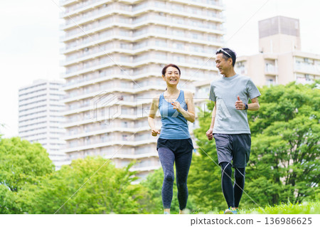 Middle-aged couple jogging Middle-aged couple jogging 136986625