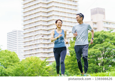 Middle-aged couple jogging Middle-aged couple jogging 136986626