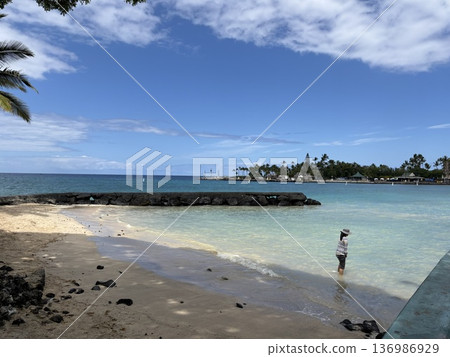 A person playing in the waves on a clear Hawaiian beach A person playing in the waves on a clear Hawaiian beach 136986929