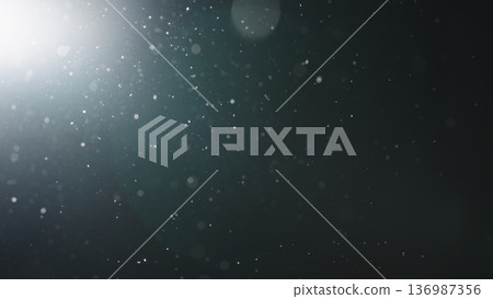background of floating particles in air over black background and lens flare 136987356