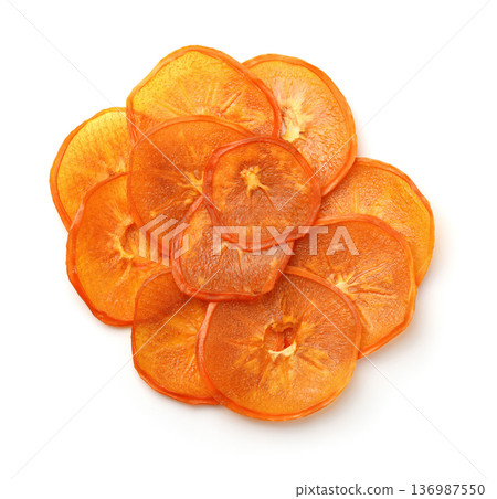 Top view of dried slices of persimmon fruit Top view of dried slices of persimmon fruit 136987550