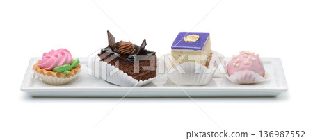 Different mini cakes on ceramic plate 136987552