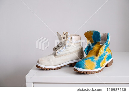 Unfinished customized shoe next to handmade tie dye custom shoe 136987586