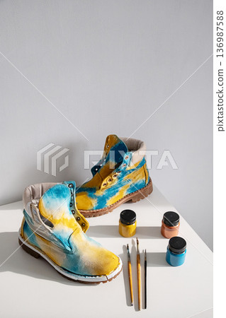 Custom painted shoes with vibrant colors and art supplies. 136987588