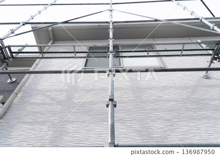 Example of a typical house: Scaffolding has begun at the exterior wall repair site 136987950