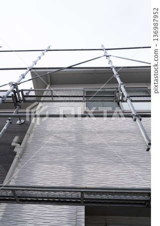 Example of a typical house: Scaffolding has begun at the exterior wall repair site 136987952