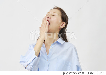 Elderly woman yawning on white background Elderly woman yawning on white background 136988170