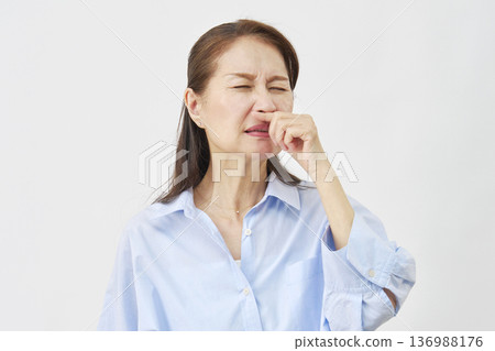 Woman with stuffy nose on white background Woman with stuffy nose on white background 136988176