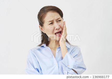 Woman suffering from toothache on white background Woman suffering from toothache on white background 136988177