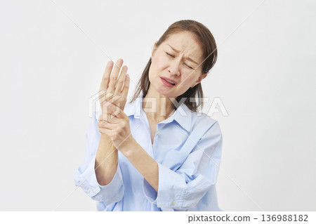 Woman suffering from hand pain on white background Woman suffering from hand pain on white background 136988182
