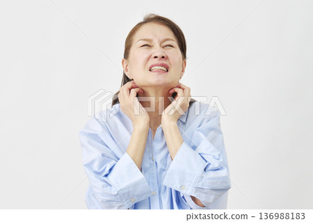A woman scratching her neck on a white background A woman scratching her neck on a white background 136988183