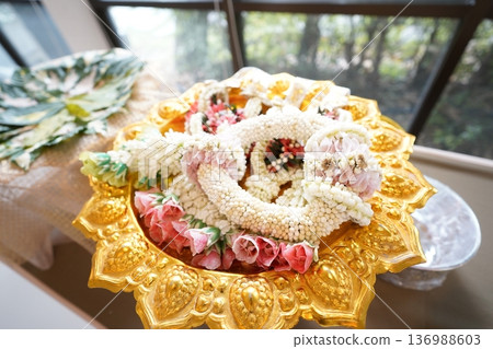 Portrait of jasmine and rose garland top golden tray. Jasmine garland is a handicraft that often used for events. 136988603