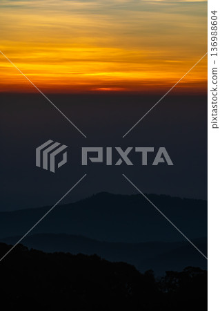 The beautiful sunrise at Doi intanon national park, Chiang Mai in the morning.Sun is rising from the hill to shy with beautiful yellow orange light. 136988604