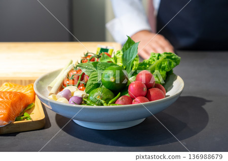 Ingredients of Spicy salad are prepared on black granite top table with various vegetable and herb. Ingredients of Spicy salad are prepared on black granite top table with various vegetable and herb. 136988679