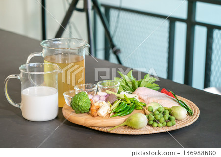 The ingredients, including chicken wings, chilli, kaffir lime leaves and lemongrass, are prepared to be cooked for a famous thai dish, Green Curry. The ingredients, including chicken wings, chilli, kaffir lime leaves and lemongrass, are prepared to be cooked for a famous thai dish, Green Curry. 136988680