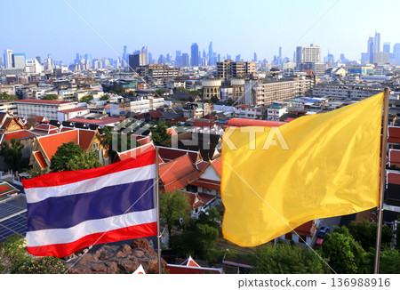 Flag of Thailand and aerial view cityscape of Bangkok with modern and old neighbourhood. Top view of Bangkok from Wat Saket Ratchawora, Thailand. Topic of summer vacation, travel, trip, cruises, tour 136988916