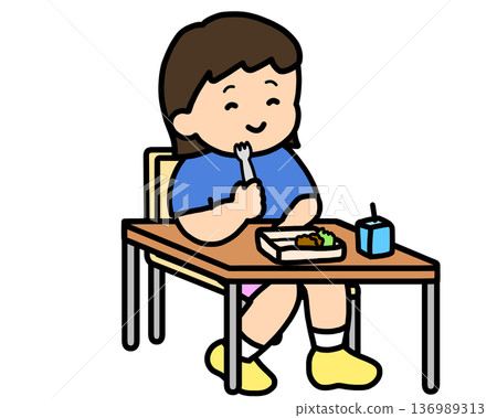 Asian girl eating lunch with a fork in the classroom 136989313