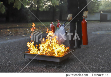 corporate safety - exercise during a firefighting course 136989383