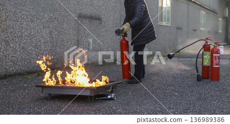 corporate safety - exercise during a firefighting course 136989386