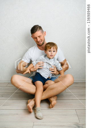 Father Holding Toddler Sitting On Floor At Home Father Holding Toddler Sitting On Floor At Home 136989466