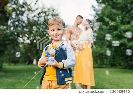 Happy Boy With Bubble Toy In Summer Garden Happy Boy With Bubble Toy In Summer Garden 136989470