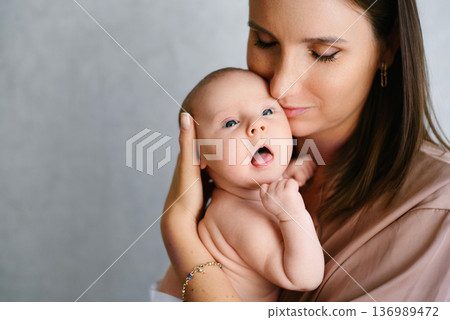 Mother Embracing Her Infant Baby Mother Embracing Her Infant Baby 136989472