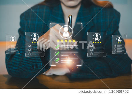 Professional woman using futuristic digital interface for employee evaluation and feedback in a corporate environment. 136989792