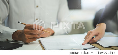Asessment business team briefing the idea and discussing exchange contract during brainstorming with paper work Asessment business team briefing the idea and discussing exchange contract during brainstorming with paper work 136990148