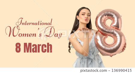 Young woman blows a kiss while holding a number eight balloon 136990415