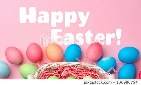 Colorful eggs in a basket with a festive greeting for Easter celebration in springtime Colorful eggs in a basket with a festive greeting for Easter celebration in springtime 136990754