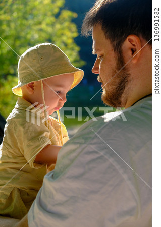 Father and Baby Relaxing in Sunny Park Father and Baby Relaxing in Sunny Park 136991582