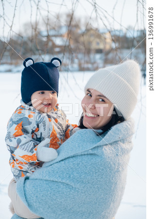 Mother and Baby Enjoying a Winter Day 136991678
