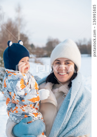 Mother and Baby Enjoying a Winter Day 136991685