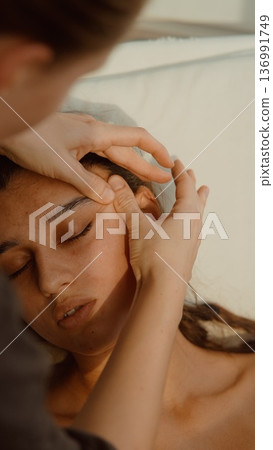 Facial massage performed to relax muscles and improve skin health 136991749