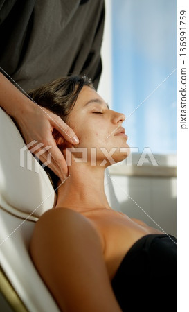 Calm neck massage session. Relaxing massage during sunset illumination Calm neck massage session. Relaxing massage during sunset illumination 136991759