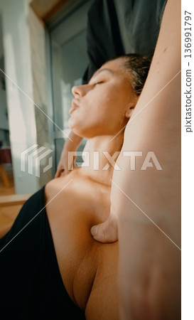 Medical setting with practitioner guiding neck stretching and alignment 136991797